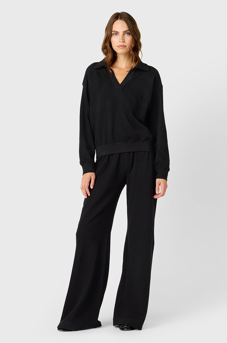 Model wearing The Lady & The Sailor Polo Sweatshirt in Black Cotton Twill and Wide Leg Pant in Black - a mid-rise wide leg sweatpant.