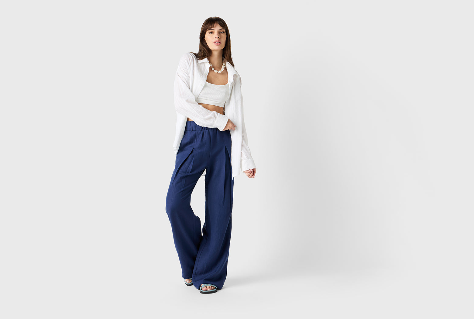 Brunette Model wearing the lady & the sailor Pleated Trouser in Nautical Navy