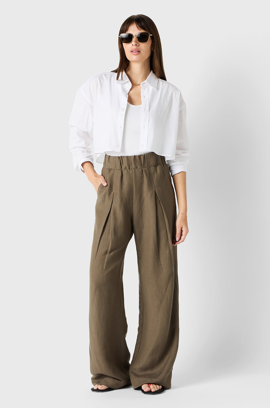 Brunette Model wearing the lady & the sailor Pleated Trouser in Moss