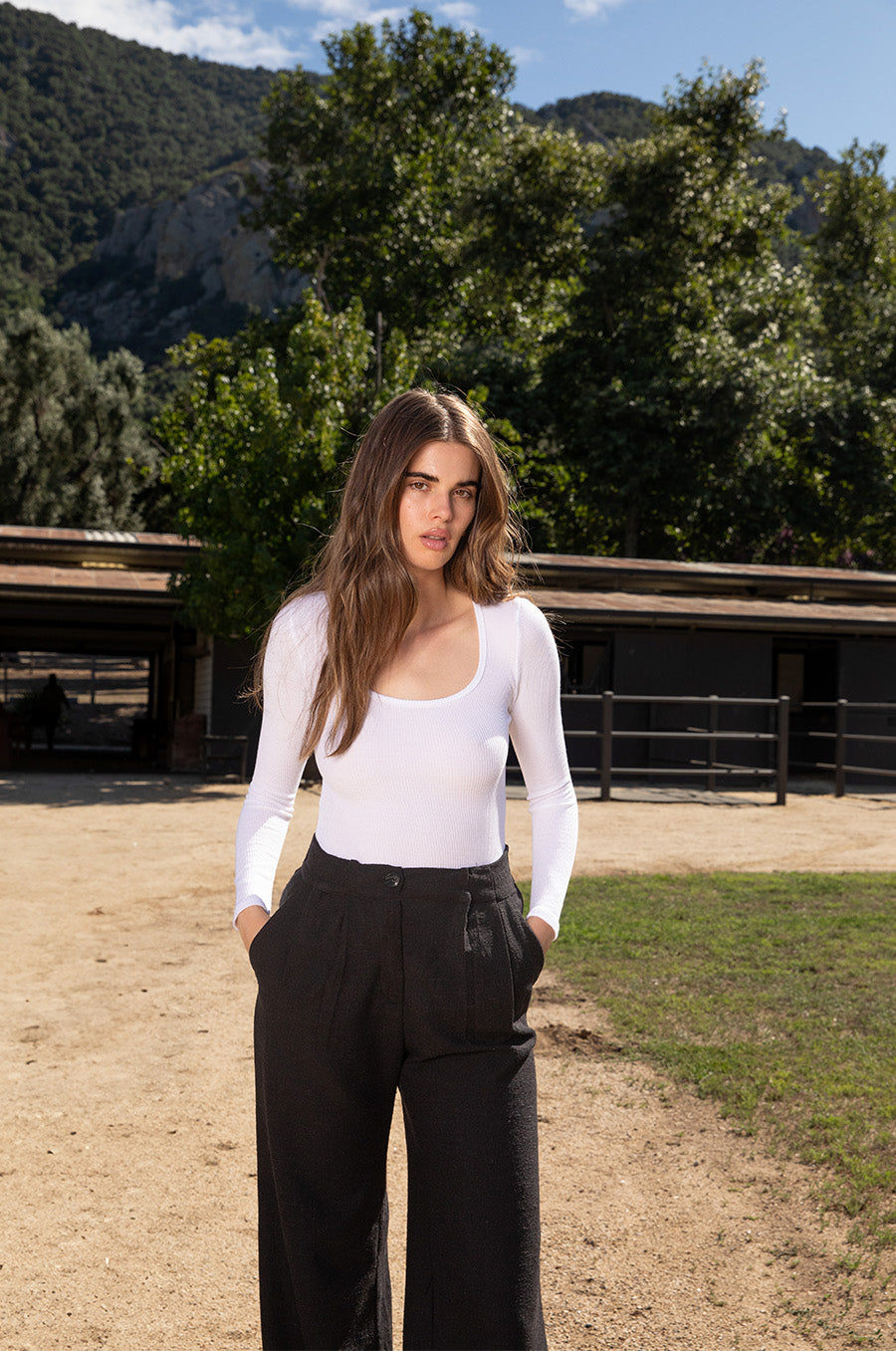 Brunette model wearing the lady & the sailor Long Sleeve Scoopneck Tee in White Thermal.